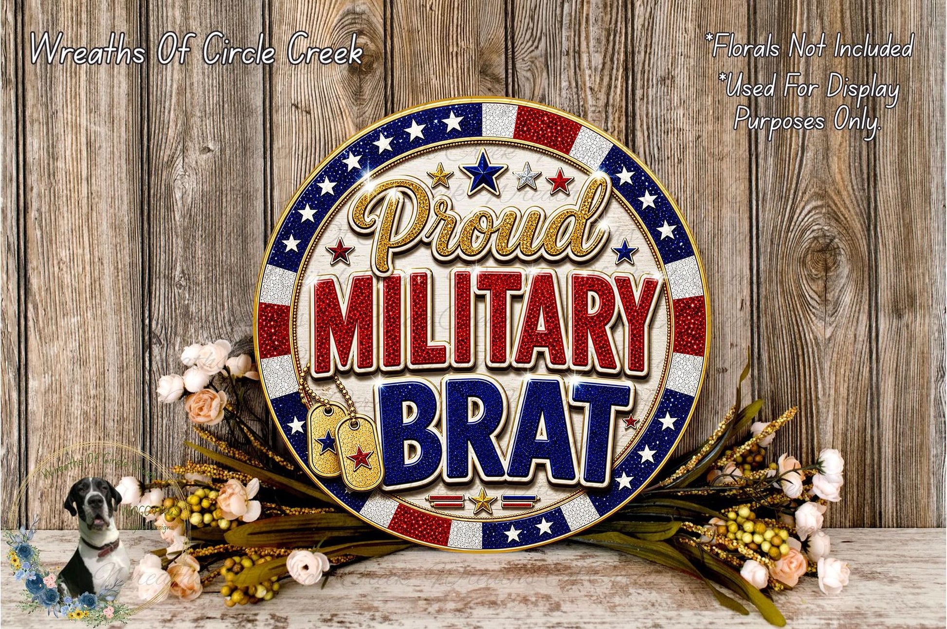 a patriotic-themed wreath with the text "Proud MILITARY BRAT" displayed prominently. The wreath is surrounded by flowers, and the background is a wooden wall.