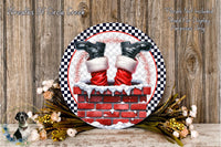 A decorative wreath with Santa Claus's feet in a chimney, surrounded by a floral arrangement and a wooden background.