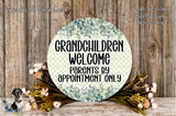 a circular sign with the text "Grandchildren Welcome" and "Parents by appointment only" written on it, surrounded by a floral arrangement and a wooden background.