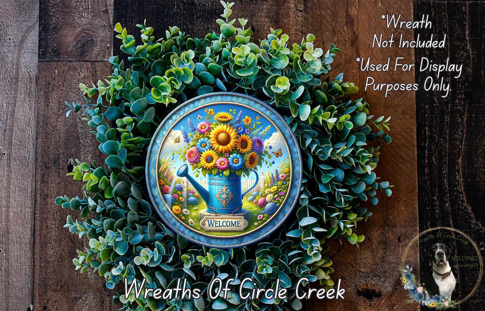 a wreath with a blue watering can and a floral arrangement, surrounded by greenery. The wreath is displayed on a wooden surface, and there is a text overlay that reads "Welcome Wreath Not Included * Used For Display Purposes Only".