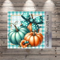 A collage of three pumpkins, one blue and two orange, with a bow on top, set against a blue and white checkered background.
