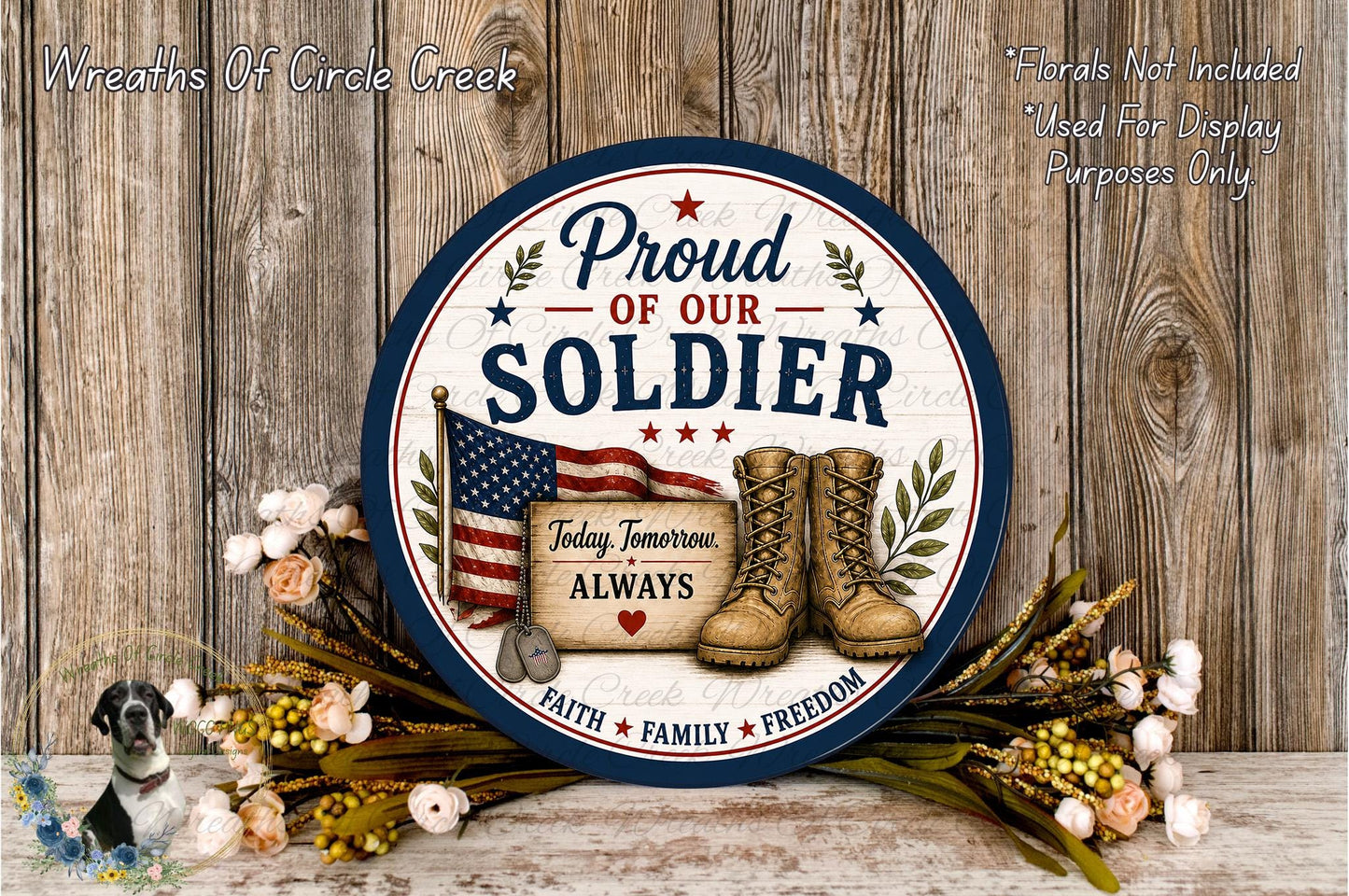a patriotic sign that reads "Proud of our SOLDIER" with an American flag and a pair of boots, surrounded by flowers and a wreath.
