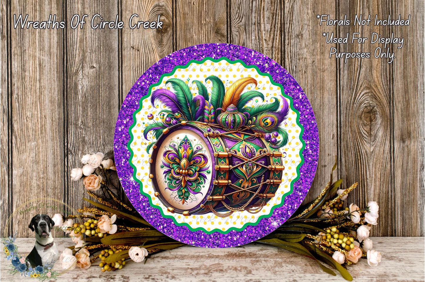 a decorative plate with a vibrant design of a drum surrounded by colorful feathers and flowers, placed on a wooden surface.