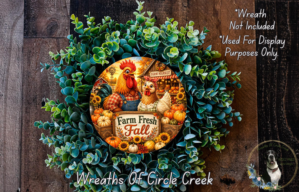 a wreath made of various fall-themed elements, including a rooster, a chicken, pumpkins, and sunflowers, all set against a wooden background.