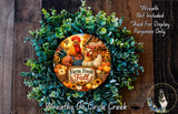 a wreath made of various fall-themed elements, including a rooster, a chicken, pumpkins, and sunflowers, all set against a wooden background.