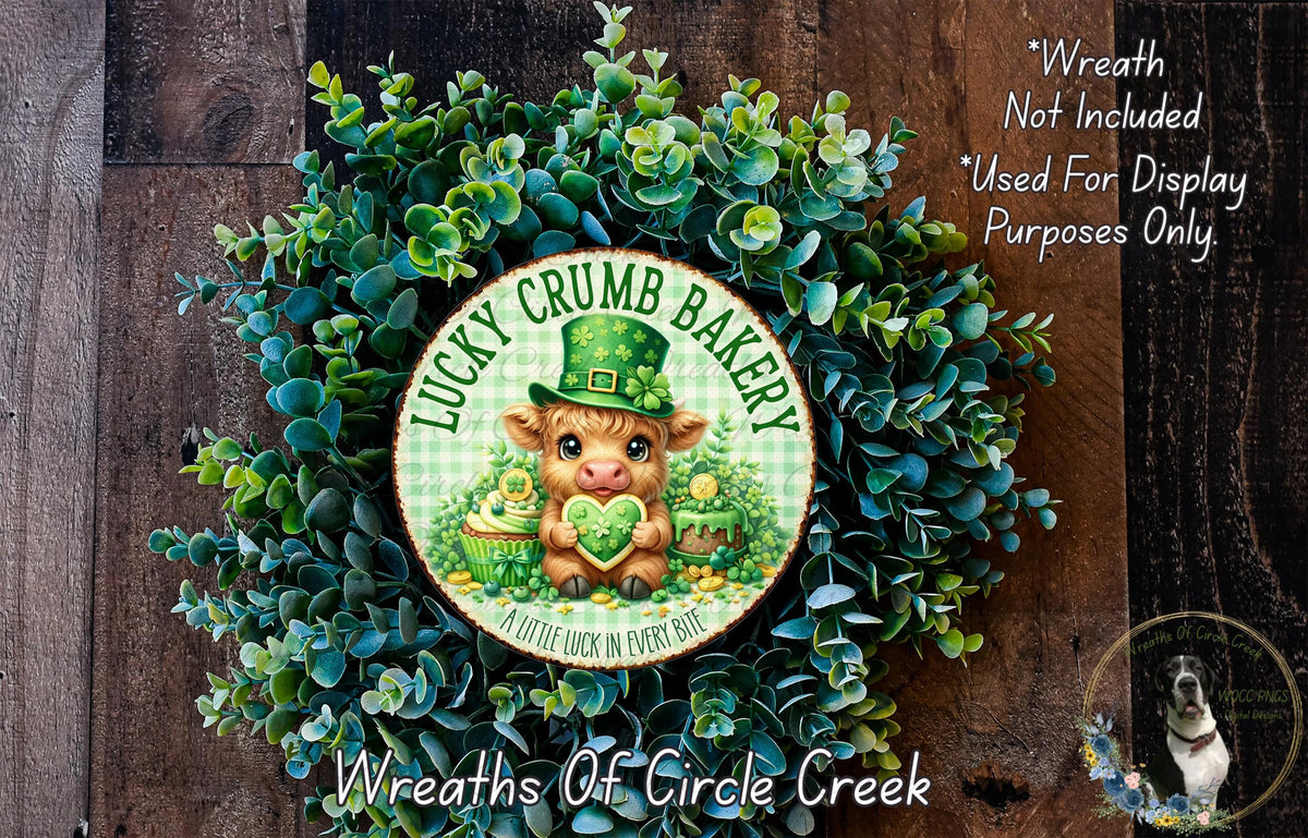 a wreath made of green leaves and a small brown cow wearing a green hat, with the text "Lucky Crumb Bakery" and "A little luck in every bite" displayed on it.