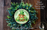 a wreath made of green leaves and a small brown cow wearing a green hat, with the text "Lucky Crumb Bakery" and "A little luck in every bite" displayed on it.