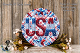 a decorative sign with the word "USA" in patriotic colors, surrounded by flowers and foliage.