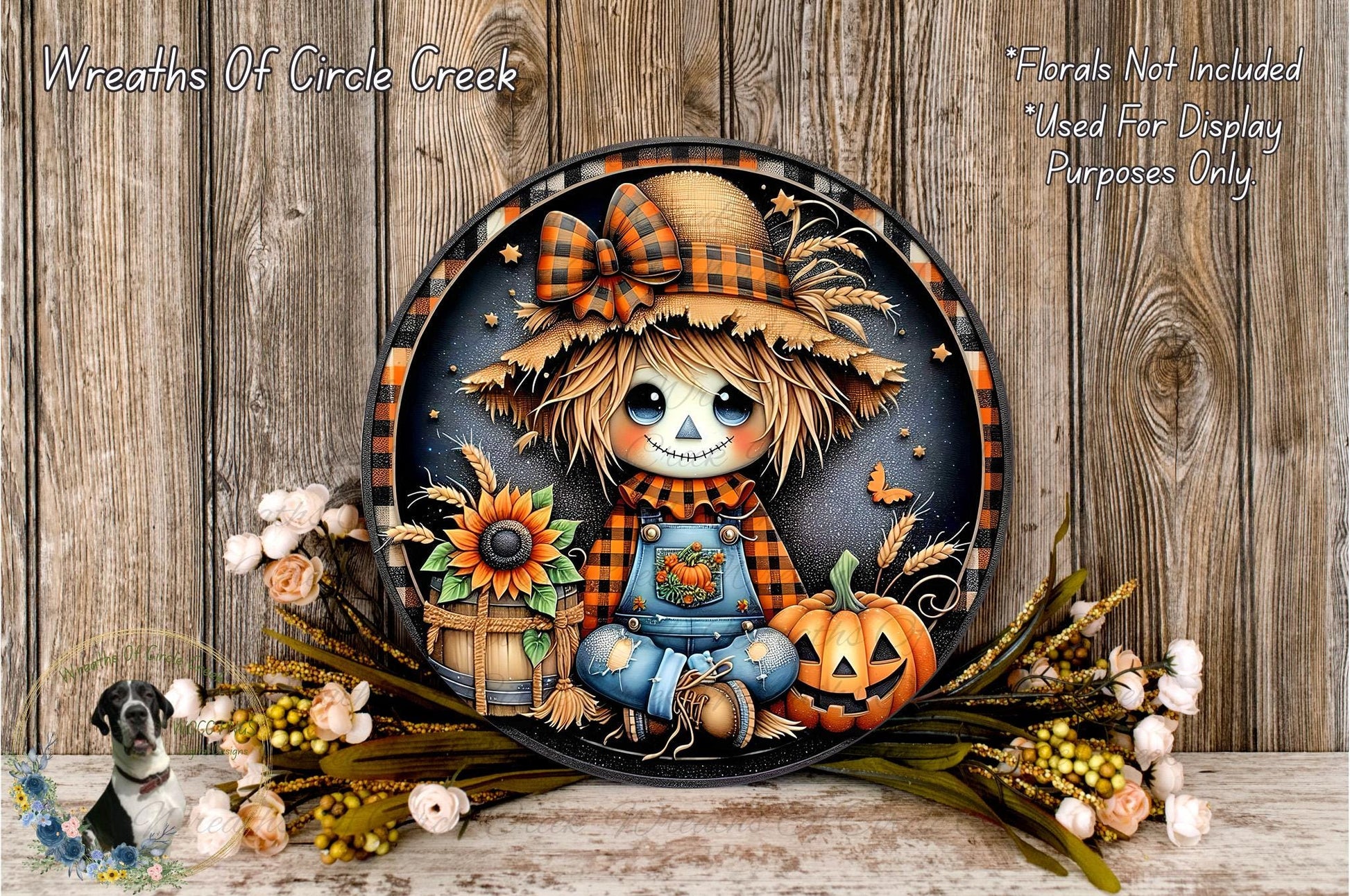 A decorative plate featuring a scarecrow with a pumpkin, flowers, and a bow, set against a wooden background.