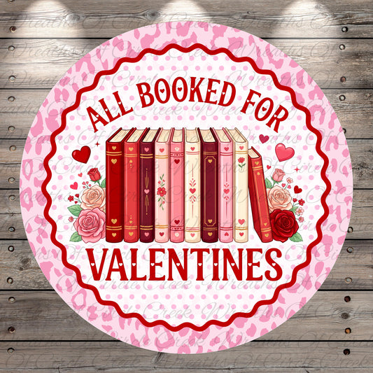A circular sign with a pink and white color scheme, featuring a row of books and the text "All Booked for Valentine's Day" in red.