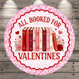 A circular sign with a pink and white color scheme, featuring a row of books and the text "All Booked for Valentine's Day" in red.