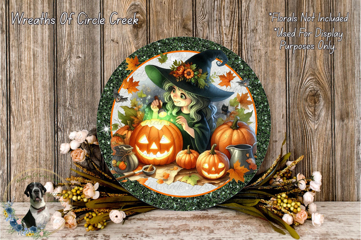 A Halloween-themed wreath featuring a witch, pumpkins, and other fall decorations, with a wooden background.