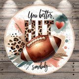 a football with a leopard print pattern, surrounded by text and a heart shape.