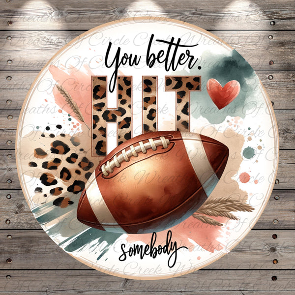 a football with a leopard print pattern, surrounded by text and a heart shape.