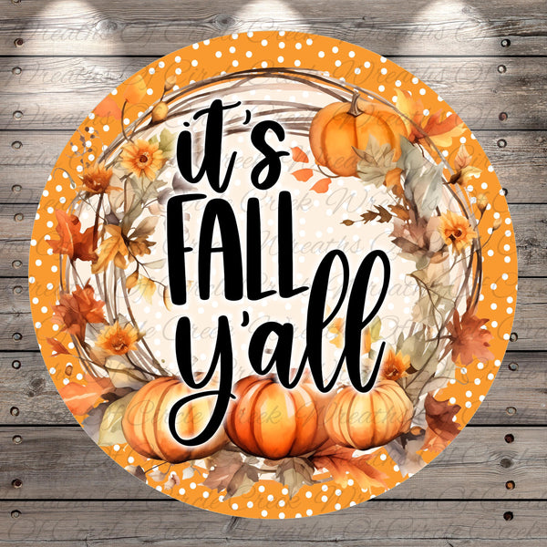 A circular decorative plate with a wreath of autumn leaves and pumpkins surrounding the text "It's FALL Y'ALL" in a vibrant orange and yellow color scheme.