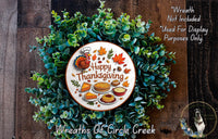 A wreath made of green leaves and autumn-themed decorations, including a turkey, pies, and other Thanksgiving-related items. The wreath is surrounded by text that reads "Happy Thanksgiving" and "Wreaths of Circle Creek".