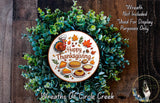 A wreath made of green leaves and autumn-themed decorations, including a turkey, pies, and other Thanksgiving-related items. The wreath is surrounded by text that reads "Happy Thanksgiving" and "Wreaths of Circle Creek".