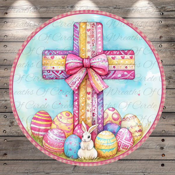 A round wreath with a large pink bow, surrounded by colorful Easter eggs and a white rabbit.
