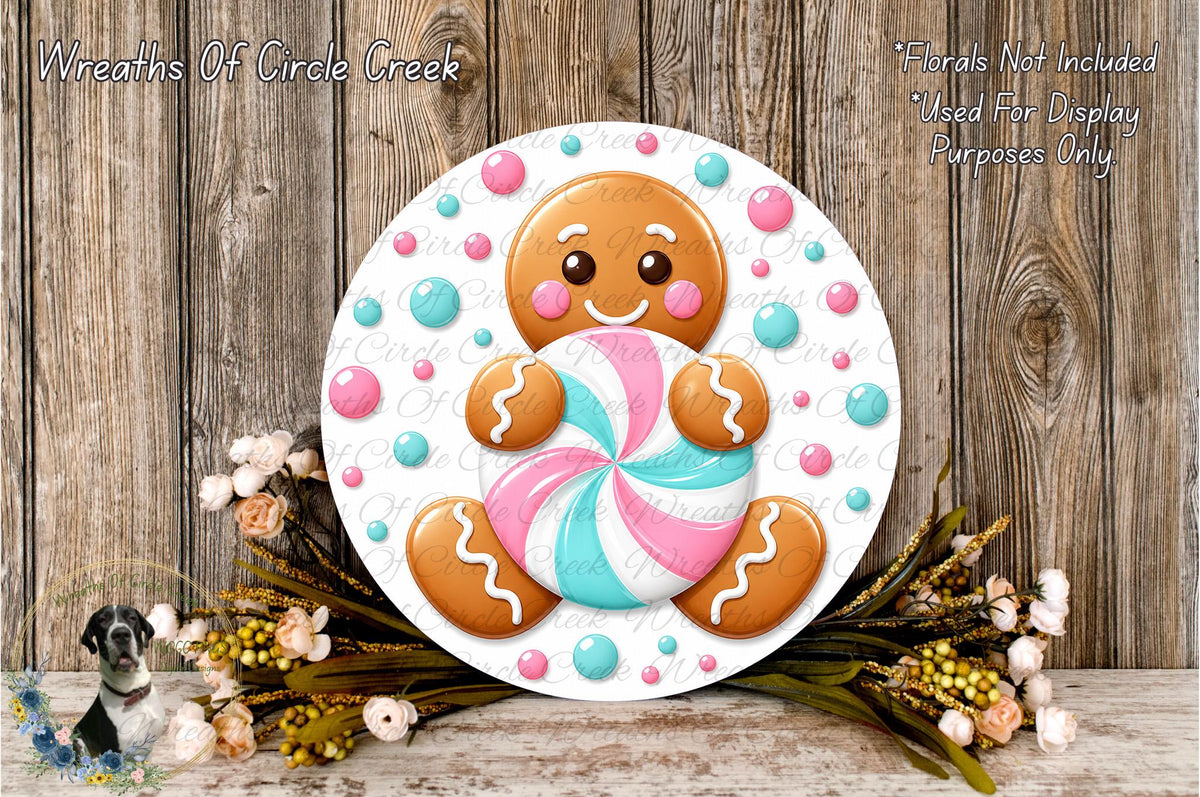 A gingerbread man figure holding a colorful candy cane is displayed on a white circular board, surrounded by a floral arrangement and placed on a wooden surface.