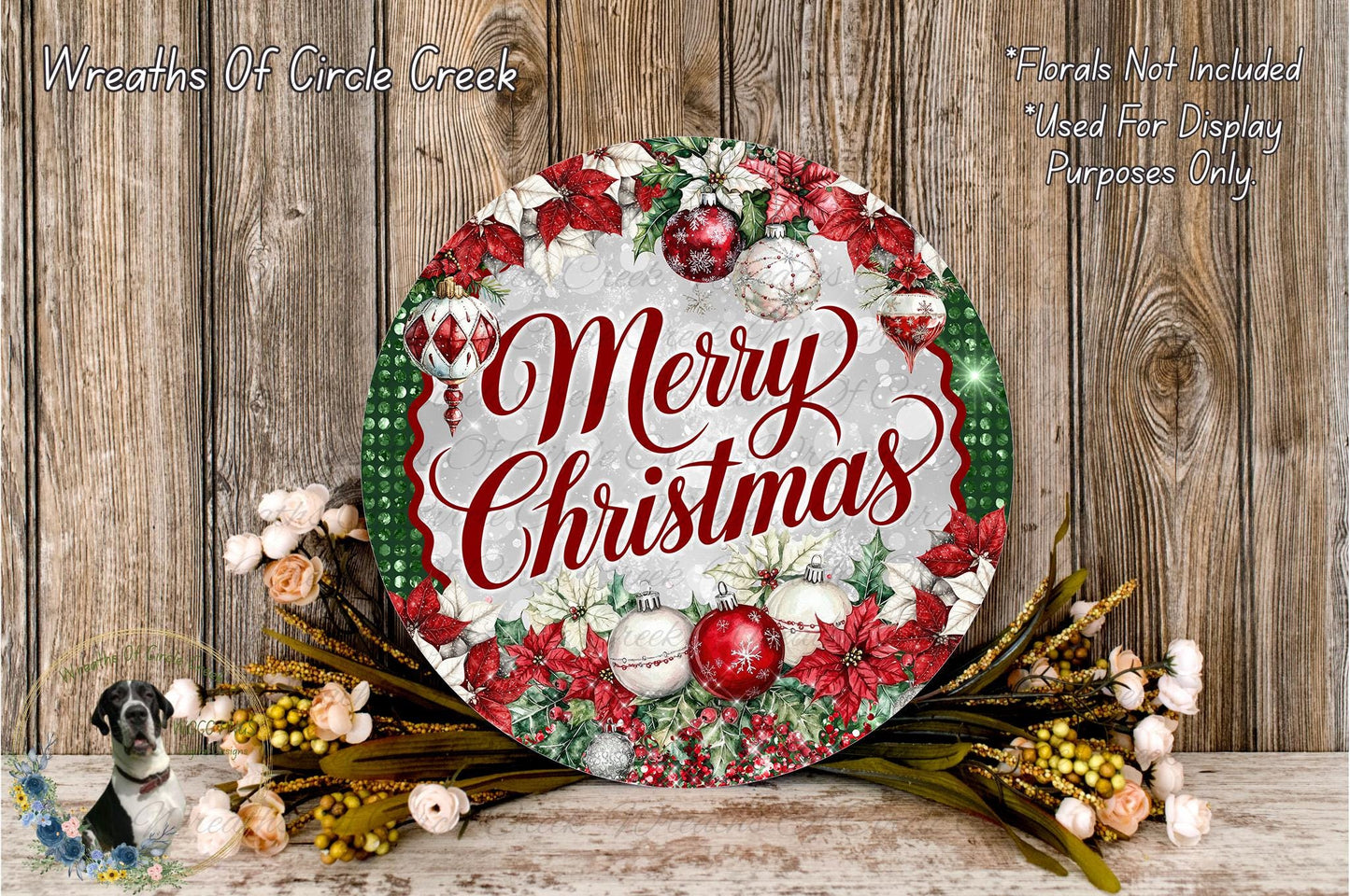 A festive Christmas wreath with the text "Merry Christmas" displayed prominently. The wreath is adorned with red and white ornaments, greenery, and flowers, creating a cheerful holiday display.