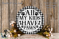 a decorative sign with the text "All My Kids Have Paws" displayed on a wooden surface. The sign is surrounded by a floral arrangement, and there is text in the top left corner that reads "Wreaths Of Circle Creek".