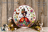 A decorative plate featuring a whimsical illustration of a ladybug surrounded by various flowers and butterflies. The plate is placed on a wooden surface, and there are also some flowers and greenery surrounding it.