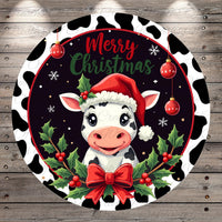 A cow wearing a Santa hat and surrounded by Christmas decorations, including holly leaves, berries, and a bow, with the text "Merry Christmas" displayed.