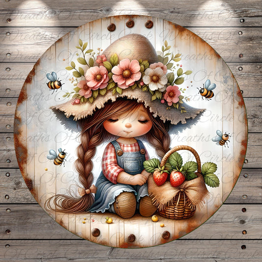 A young girl with long braided hair is sitting on a wooden surface, wearing a straw hat decorated with flowers and surrounded by a basket of strawberries and other fruits.