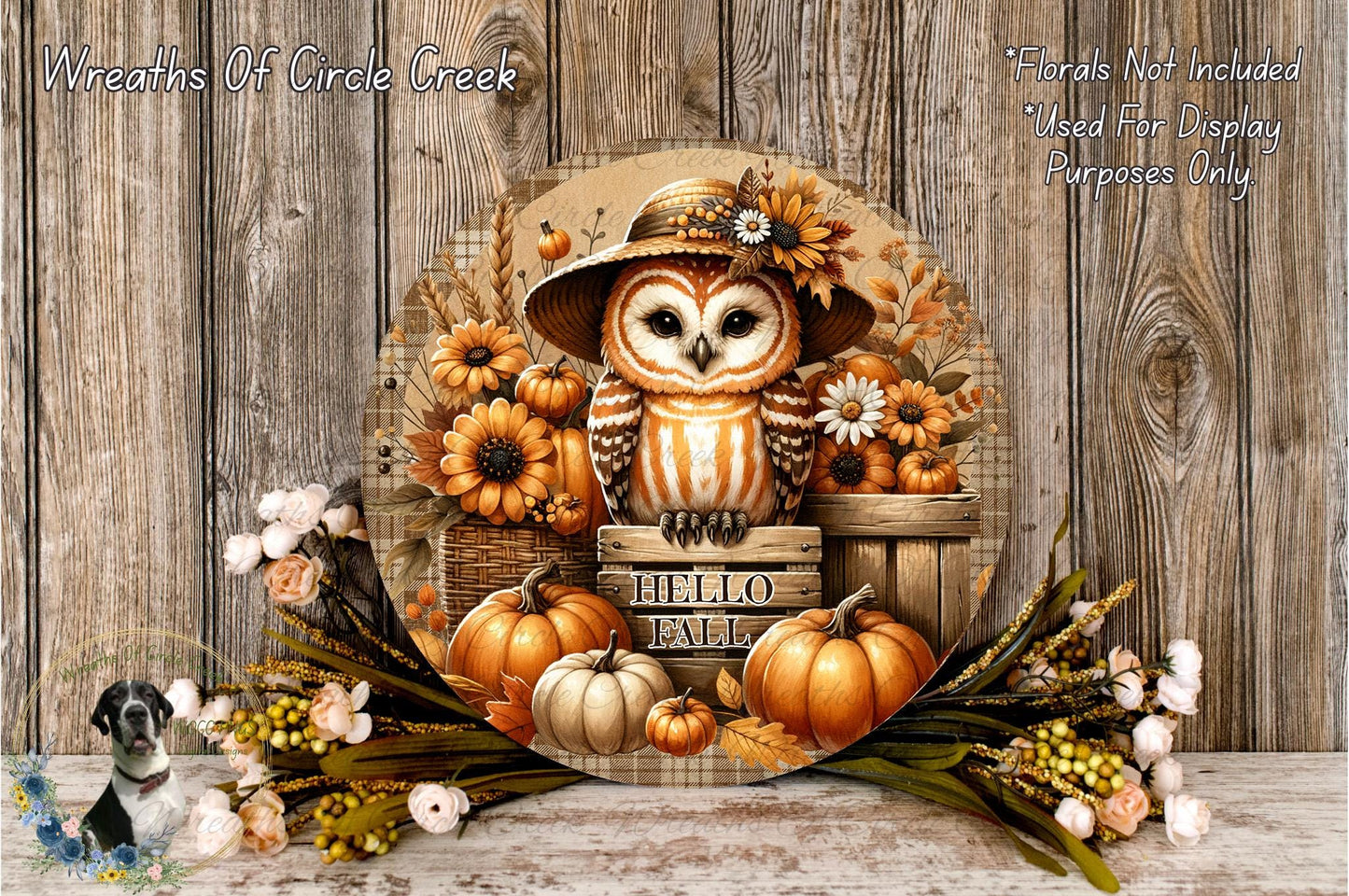 A decorative wreath featuring an owl wearing a hat and surrounded by autumn-themed elements such as pumpkins, flowers, and leaves.
