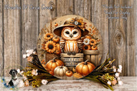 A decorative wreath featuring an owl wearing a hat and surrounded by autumn-themed elements such as pumpkins, flowers, and leaves.