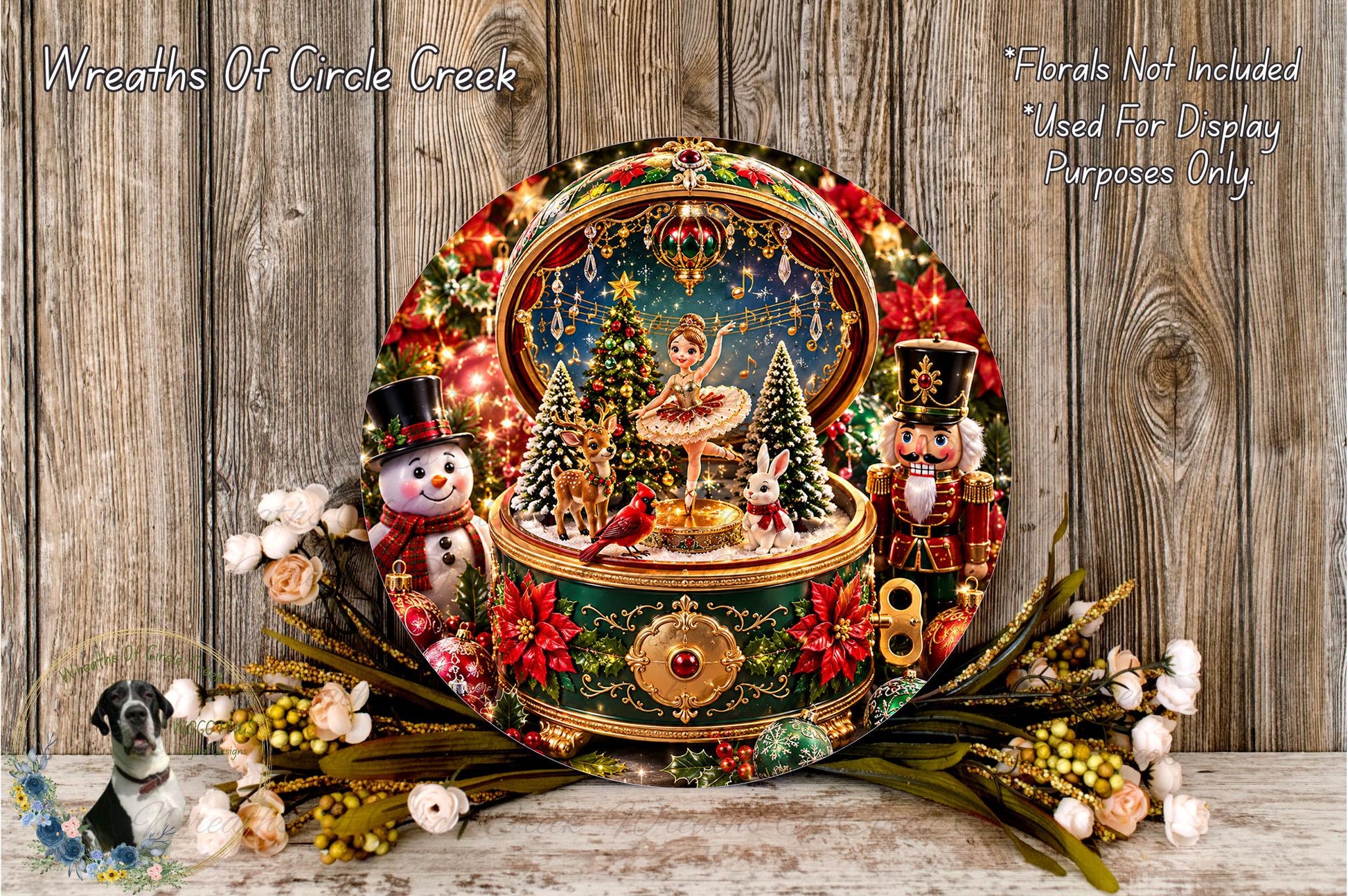 A decorative wreath with a miniature Christmas scene inside, featuring a snowman, nutcracker, and other holiday-themed elements. The wreath is surrounded by flowers and placed on a wooden surface.