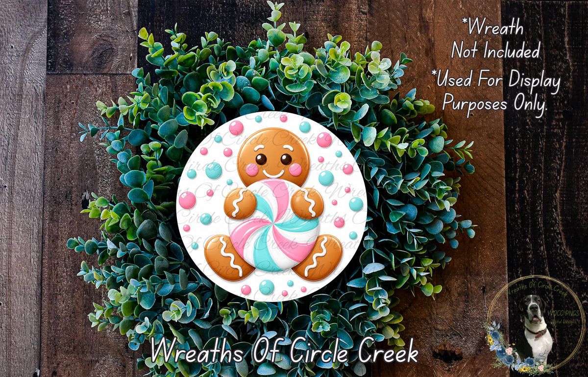 A wreath made of green foliage and featuring a gingerbread man cookie as the centerpiece.