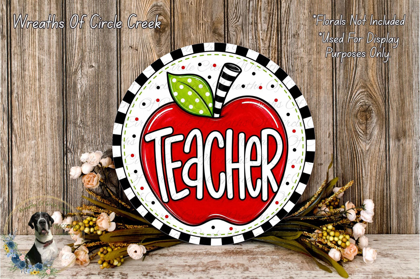 A decorative sign with the word "Teacher" written on it, surrounded by a wreath of flowers and a wooden background.