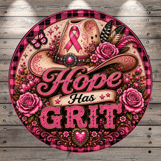 The image is a vibrant and colorful illustration featuring a cowboy hat adorned with a pink ribbon, surrounded by pink roses, butterflies, and other floral elements. The text "Hope Has Grit" is prominently displayed in the center of the image, conveying a message of resilience and determination.