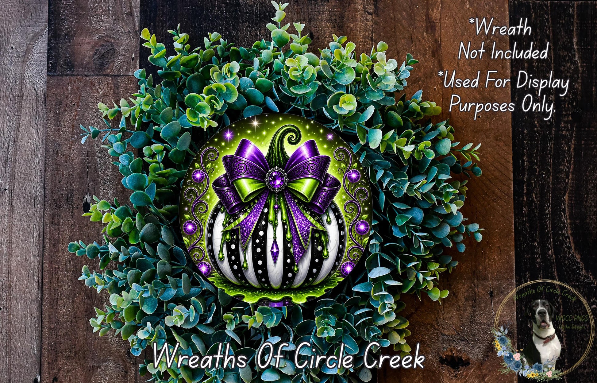 a wreath with a large purple bow and a green and white striped pumpkin at the center, surrounded by a lush green plant. The wreath is displayed on a wooden surface, and there is a small dog in the bottom right corner of the image.