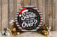 a decorative sign with a Santa hat and the text "Dear Santa, can I have a do over?". The sign is surrounded by a wreath of flowers and placed on a wooden surface.
