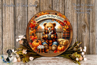 A wooden plaque with a teddy bear wearing a plaid scarf and holding a mug, surrounded by autumn decorations such as pumpkins, leaves, and flowers, with the text &quot;Welcome To Our Cabin&quot; and &quot;Flors Not Included Used For Display Purposes Only&quot;.