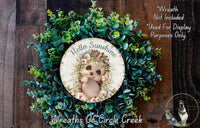 a wreath with a picture of a baby bear on it