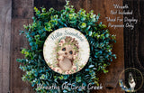 a wreath with a picture of a baby bear on it