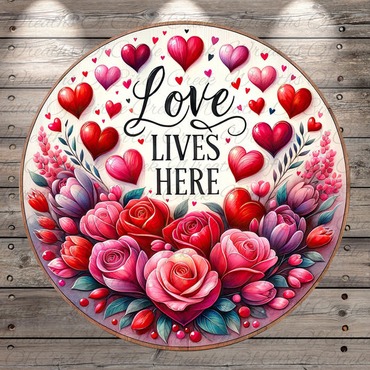 The image is a circular design featuring a floral arrangement with red roses and hearts, surrounded by the text "Love lives here".