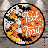 a Halloween-themed design with a circular border, featuring candy corn, bats, and the text "Trick or Treat".