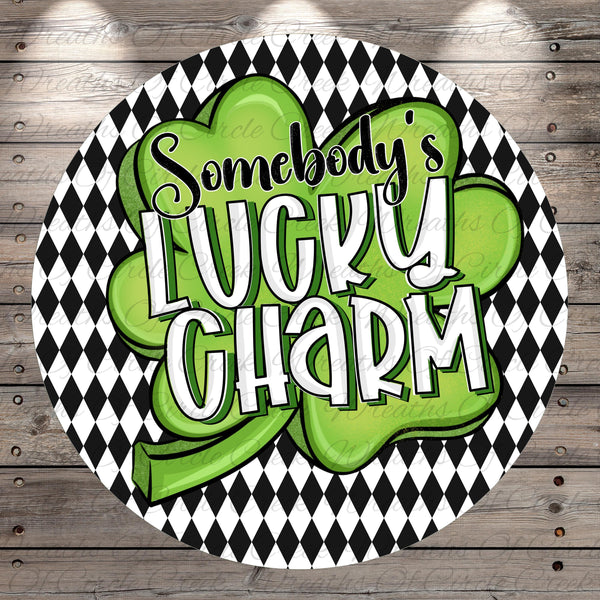 a circular design with a black and white checkered pattern and a green clover-shaped symbol. The text "SOMEBODY'S LUCKY CHARM" is prominently displayed in the center of the design.