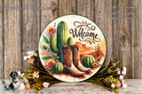 a decorative plate with a welcoming message, surrounded by various elements such as cacti, flowers, and boots, all set against a rustic wooden background.