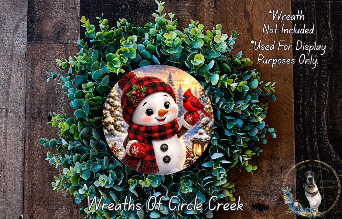 A wreath featuring a snowman and a red cardinal bird, surrounded by green foliage.