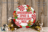 A festive wreath with a gingerbread spice and everything nice theme, featuring gingerbread men and red and white striped candy canes. The wreath is displayed on a wooden surface, surrounded by flowers.