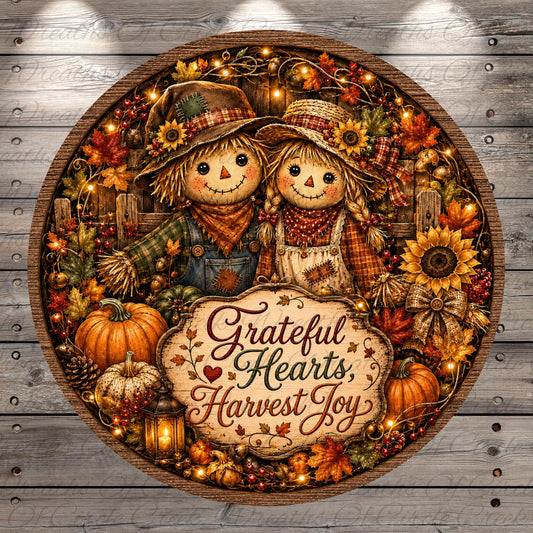A round wreath with two scarecrow dolls, a sign that says "Grateful Hearts, Harvest Joy", and various fall-themed decorations such as pumpkins, sunflowers, and leaves.