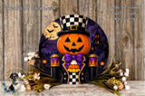 A Halloween-themed wreath featuring a jack-o-lantern wearing a top hat and bow tie, surrounded by flowers and a castle in the background.