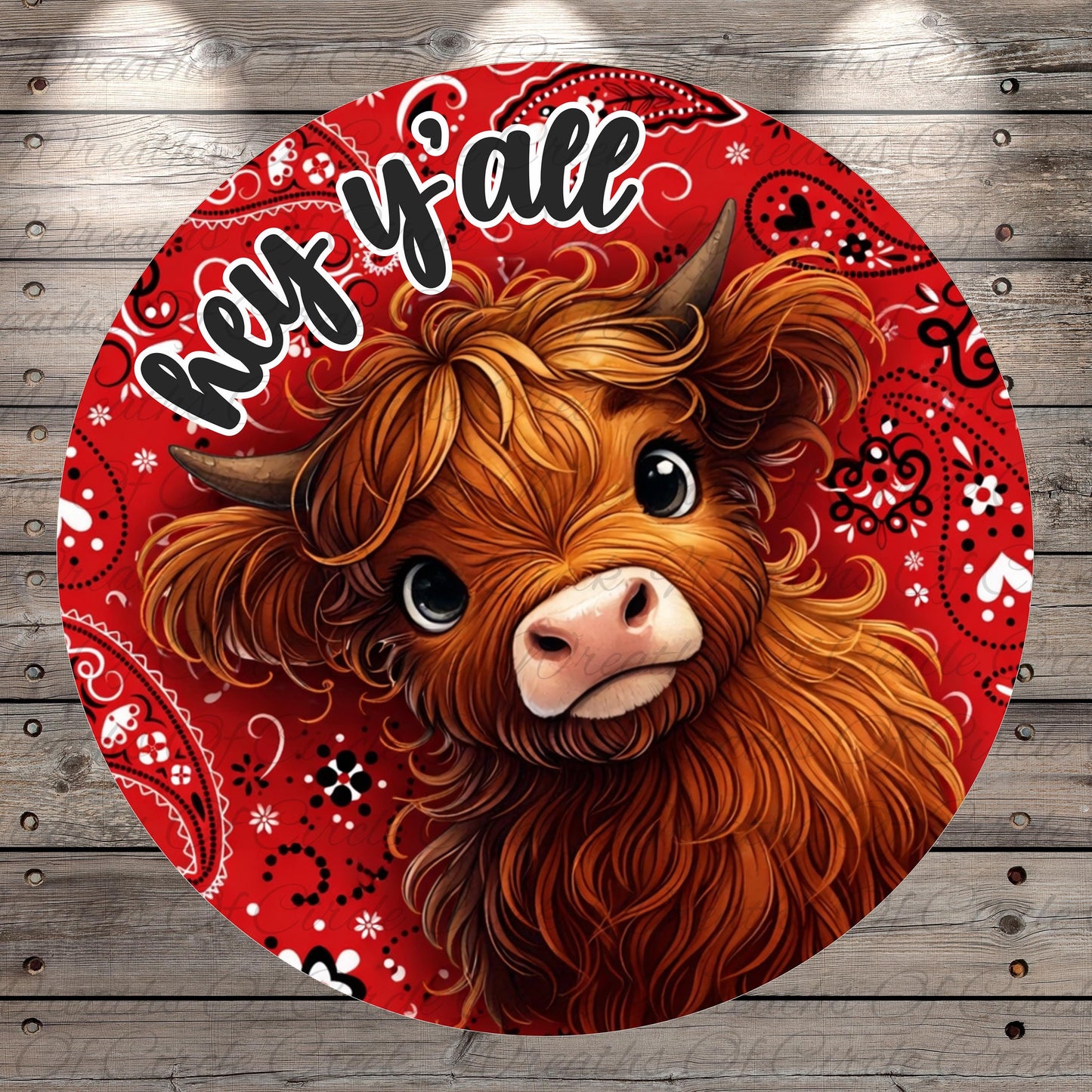 A close-up of a brown cow with horns, surrounded by a red and white paisley pattern. The cow is looking directly at the camera with a friendly expression.