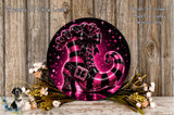 A decorative wreath featuring a large, glittery black and pink striped boot as the centerpiece, surrounded by flowers and placed on a wooden surface.