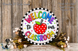A colorful welcome sign for a classroom, featuring a red apple with polka dots and the text "Welcome to our Classroom" in a circular design.